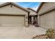 House exterior featuring a three-car garage and walkway at 7606 E Globemallow Ln, Gold Canyon, AZ 85118