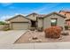 Single-story home with a two-car garage and desert landscaping at 7606 E Globemallow Ln, Gold Canyon, AZ 85118