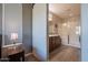 Main bathroom with walk-in shower and barn door at 86 E Iloca Ln, Queen Creek, AZ 85140