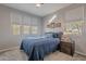 Bright bedroom with a queen bed and window seating at 86 E Iloca Ln, Queen Creek, AZ 85140