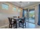 Dining area with wooden table, sliding glass doors, and backyard access at 86 E Iloca Ln, Queen Creek, AZ 85140