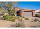 Single-story home with a two-car garage and desert landscaping at 86 E Iloca Ln, Queen Creek, AZ 85140