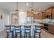 Granite kitchen island with seating and stainless steel appliances at 86 E Iloca Ln, Queen Creek, AZ 85140