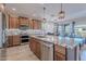 Spacious kitchen featuring a large island with granite countertops and stainless steel appliances at 86 E Iloca Ln, Queen Creek, AZ 85140