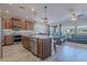 Open-concept kitchen with a large island, granite countertops, and views of the living room at 86 E Iloca Ln, Queen Creek, AZ 85140