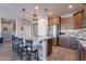 Modern kitchen with granite countertops, stainless steel appliances, and wooden cabinetry at 86 E Iloca Ln, Queen Creek, AZ 85140