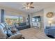 Living room with comfortable seating, large windows, and a ceiling fan at 86 E Iloca Ln, Queen Creek, AZ 85140