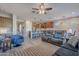 Spacious living room with leather sofas and ceiling fan at 86 E Iloca Ln, Queen Creek, AZ 85140