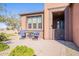 Cozy patio area with seating for two, adjacent to the home entrance at 86 E Iloca Ln, Queen Creek, AZ 85140