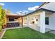 Landscaped backyard with a covered patio and outdoor kitchen at 8740 W Bloomfield Rd, Peoria, AZ 85381