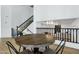 Farmhouse dining table with black chairs in bright dining area at 8740 W Bloomfield Rd, Peoria, AZ 85381