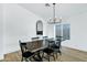 Bright dining room features a wood table with black chairs and a modern chandelier at 8740 W Bloomfield Rd, Peoria, AZ 85381