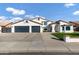 White two-story house with a three-car garage and manicured lawn at 8740 W Bloomfield Rd, Peoria, AZ 85381