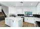 Modern kitchen with white cabinets, marble island, and stainless steel appliances at 8740 W Bloomfield Rd, Peoria, AZ 85381