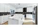 Modern kitchen with white cabinets, marble countertops, and stainless steel appliances at 8740 W Bloomfield Rd, Peoria, AZ 85381