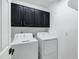 Laundry room with washer, dryer, and dark cabinets at 8740 W Bloomfield Rd, Peoria, AZ 85381