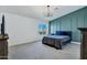 Main bedroom with large window, green accent wall and neutral bedding at 8740 W Bloomfield Rd, Peoria, AZ 85381