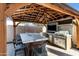 Outdoor kitchen with seating and a large flat screen TV at 8740 W Bloomfield Rd, Peoria, AZ 85381