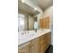 Bathroom with double vanity and wood cabinets at 9580 E Southwind Ln, Scottsdale, AZ 85262