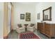 Sitting area with two armchairs, a wooden dresser, and a rug at 9580 E Southwind Ln, Scottsdale, AZ 85262