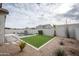 Expansive backyard with artificial turf, pool, and desert landscaping at 10053 E Seismic Ave, Mesa, AZ 85212