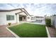 Landscaped backyard featuring a refreshing pool and putting green at 10053 E Seismic Ave, Mesa, AZ 85212