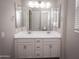 Double vanity bathroom with large mirror and bright lighting at 10053 E Seismic Ave, Mesa, AZ 85212