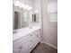 Bathroom with double vanity, white cabinets, and tile flooring at 10053 E Seismic Ave, Mesa, AZ 85212