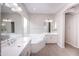 Spa-like bathroom with double sinks, a large tub, and a window at 10053 E Seismic Ave, Mesa, AZ 85212