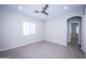 Bright bedroom with ceiling fan and wood-look flooring at 10053 E Seismic Ave, Mesa, AZ 85212