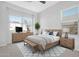 Tranquil bedroom with a light wood dresser, a cozy bed, and plenty of natural light from two windows at 10053 E Seismic Ave, Mesa, AZ 85212