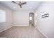 Spacious bedroom with ceiling fan and wood-look flooring at 10053 E Seismic Ave, Mesa, AZ 85212