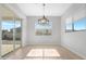 Bright dining room with sliding glass doors and wood-look floors at 10053 E Seismic Ave, Mesa, AZ 85212