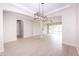 Open concept dining room with light wood floors and modern chandelier at 10053 E Seismic Ave, Mesa, AZ 85212