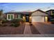 Brick home with white garage door, landscaping, and walkway at 10053 E Seismic Ave, Mesa, AZ 85212