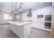 Modern kitchen with granite countertops, stainless steel appliances, and an island at 10053 E Seismic Ave, Mesa, AZ 85212