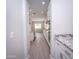 View of kitchen from hallway, granite counters and island at 10053 E Seismic Ave, Mesa, AZ 85212