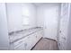 Laundry room with granite countertop and white cabinets at 10053 E Seismic Ave, Mesa, AZ 85212