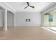 Living room with hardwood floors, ceiling fan, and sliding glass doors to patio at 10053 E Seismic Ave, Mesa, AZ 85212