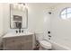 Updated bathroom features a vanity with modern fixtures and a large bathtub at 10828 E Flintlock Dr, Sun Lakes, AZ 85248