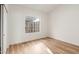 Bright bedroom with wood-look flooring and a window at 10828 E Flintlock Dr, Sun Lakes, AZ 85248