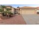 Tan two-car garage home with desert landscaping and a walkway at 10828 E Flintlock Dr, Sun Lakes, AZ 85248