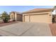 Two-car garage with light tan exterior and a large driveway at 10828 E Flintlock Dr, Sun Lakes, AZ 85248