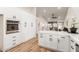 Modern kitchen with white cabinets and stainless steel appliances at 10828 E Flintlock Dr, Sun Lakes, AZ 85248