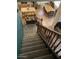 View of a carpeted staircase with wooden railings, overlooking a kitchen and dining area at 11433 E Peterson Ave, Mesa, AZ 85212