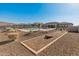 Spacious backyard oasis with a pool, fire pit, and a cornhole setup at 11842 W Creosote Dr, Peoria, AZ 85383