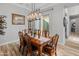 Elegant dining room with a large wood table and chandelier at 11842 W Creosote Dr, Peoria, AZ 85383