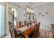 Bright dining room with a table, chandelier, and view to backyard at 11842 W Creosote Dr, Peoria, AZ 85383