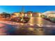 Desert home with brick driveway and Saguaro cactus at night at 11842 W Creosote Dr, Peoria, AZ 85383