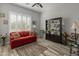 Bright living room features a red couch and a built-in bookcase at 11842 W Creosote Dr, Peoria, AZ 85383